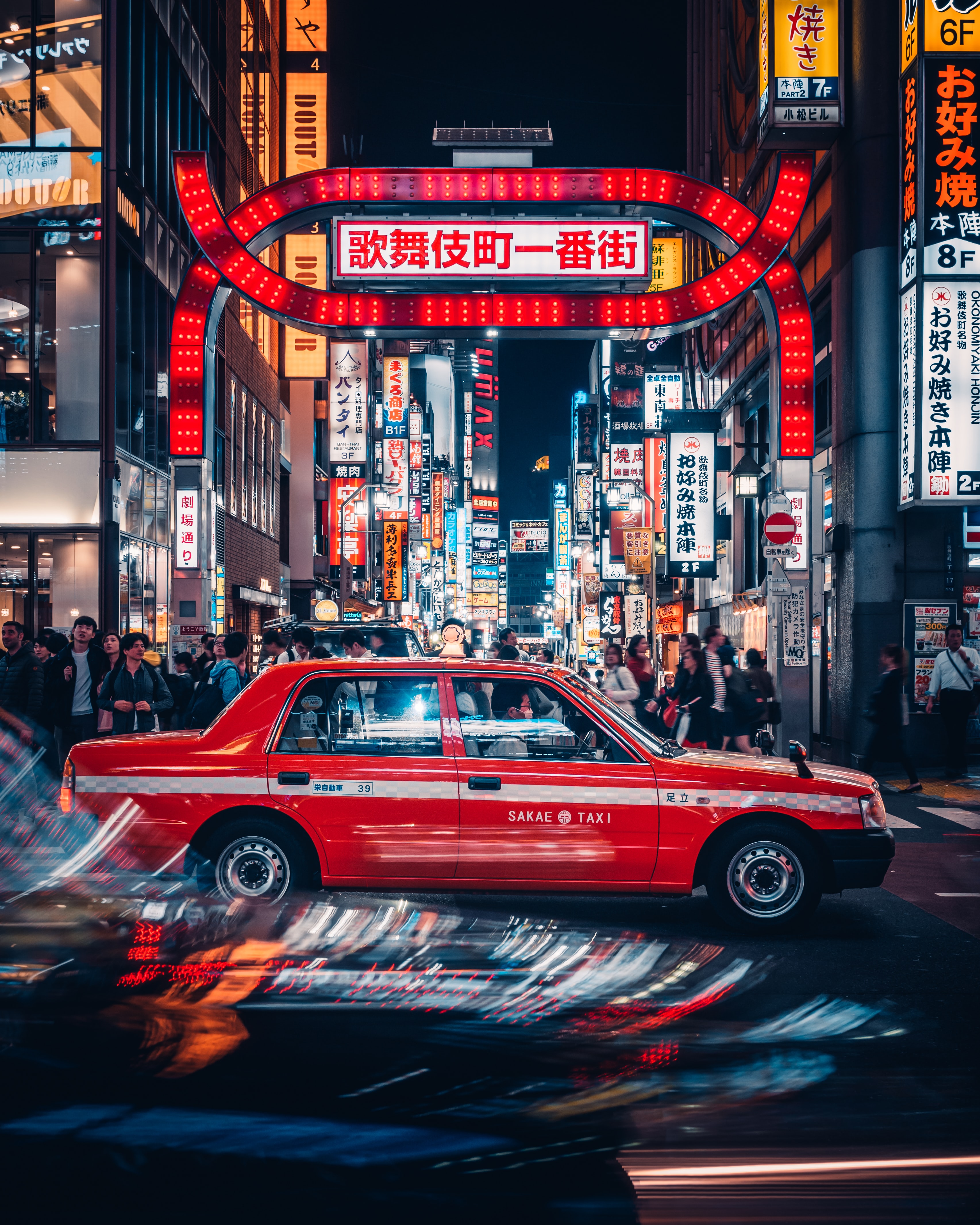 Bright red neon sign and car